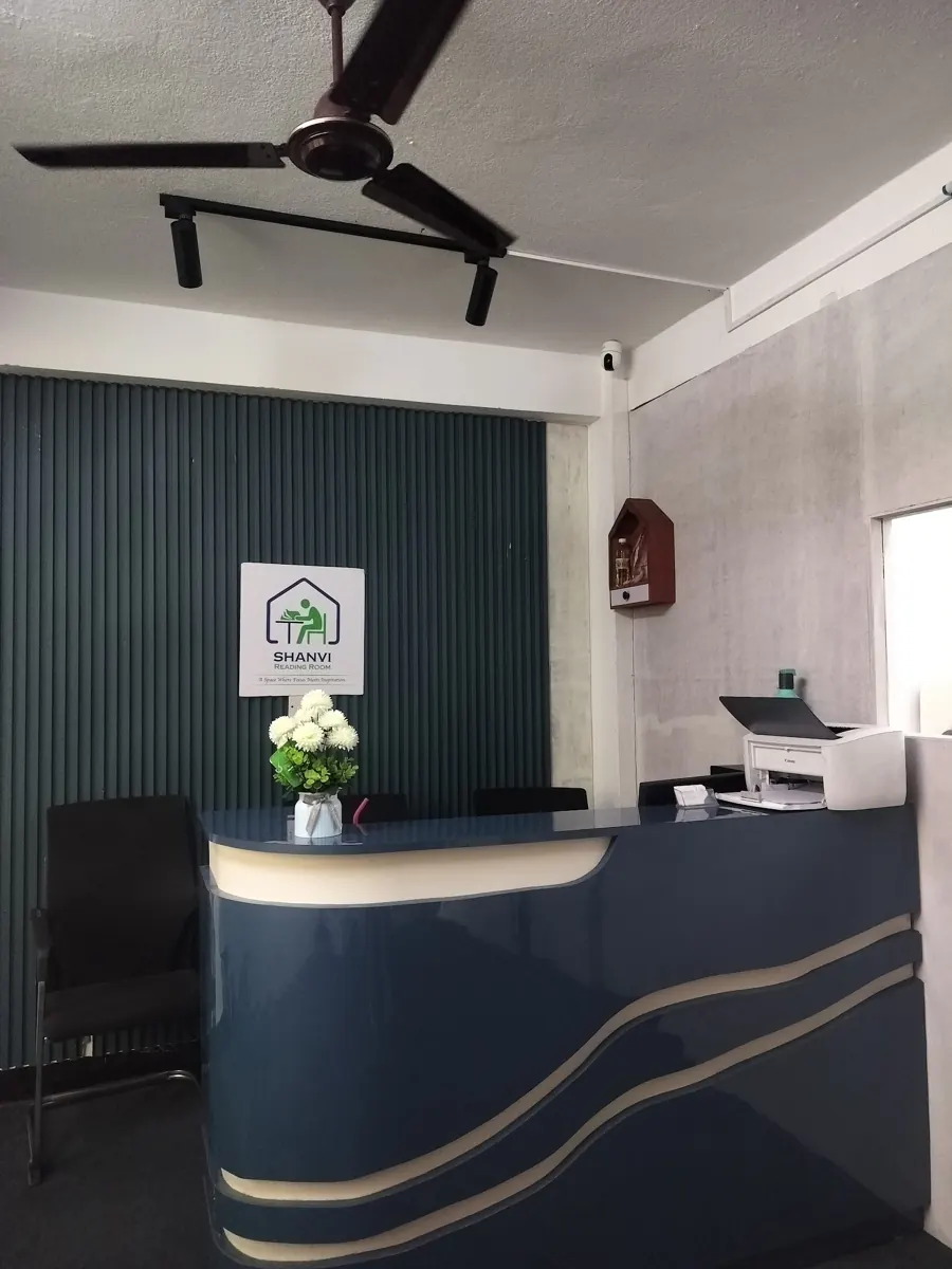 The Panga reception desk in navy and cream, with the Shanvi logo and flowers behind it.